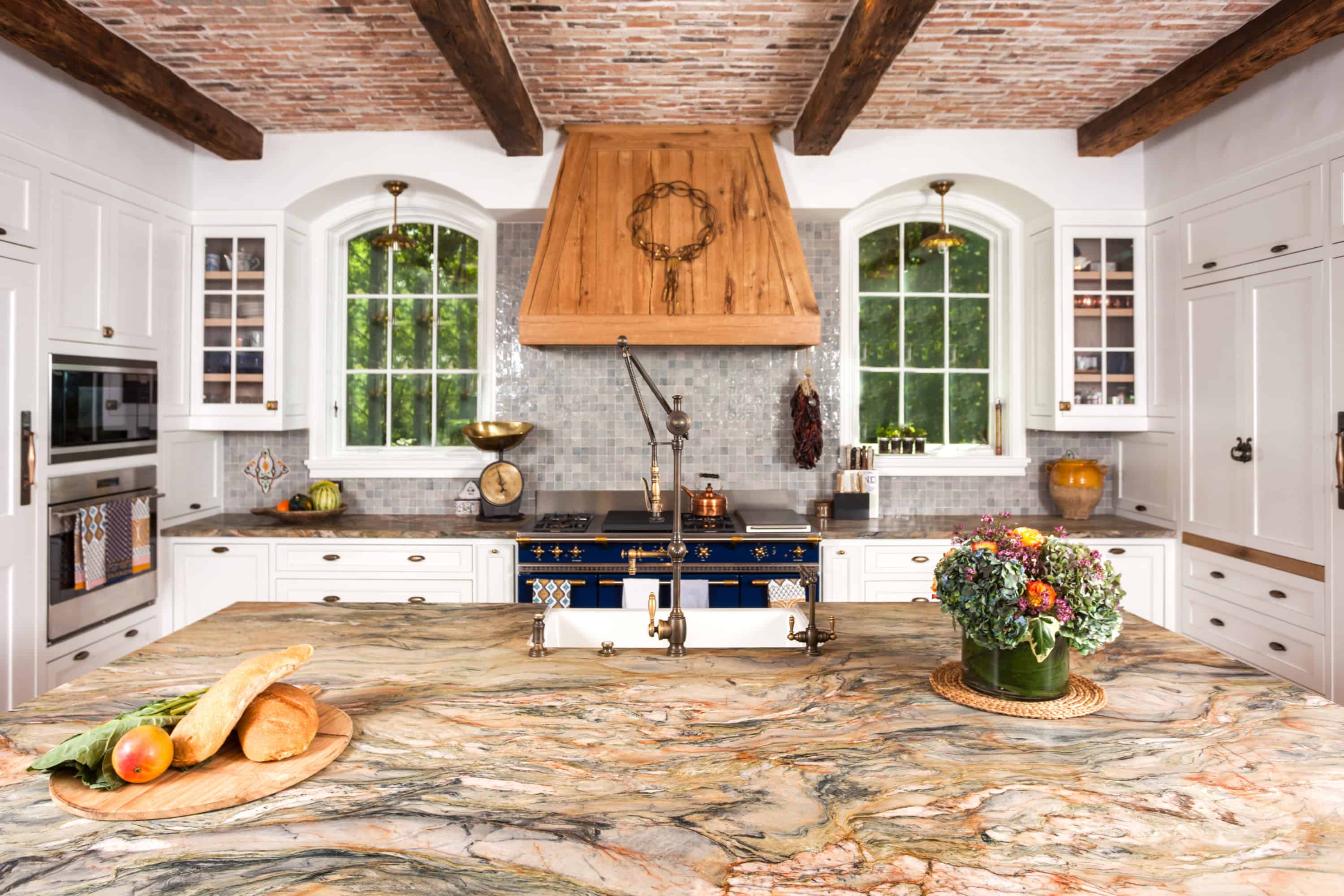 Stunning kitchen uses natural stone everywhere and we love it