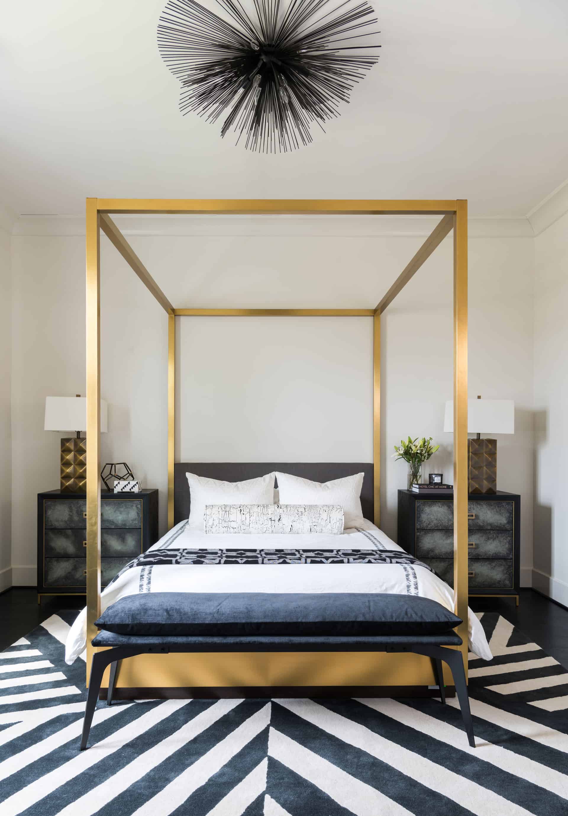 A bold geometric rug plays well with this metallic bed frame