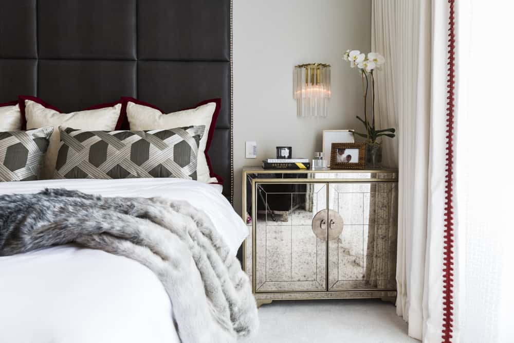 Mirrored night stand from Century Furniture takes center stage in this collected style bedroom