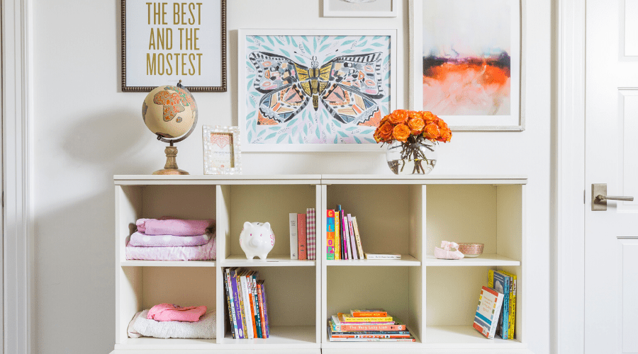 A butterfly art print from Lulie Wallace rests above two 6 cubby organizers.