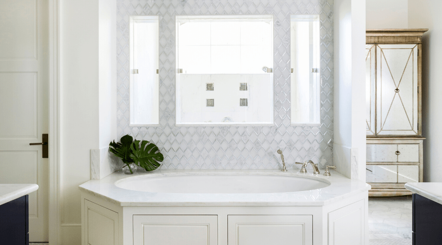 A tub and shower center this blue and white master bath.