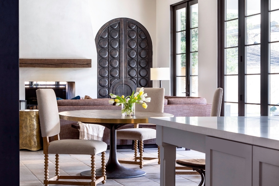 A view into the breakfast area with pedestal table in Houston home