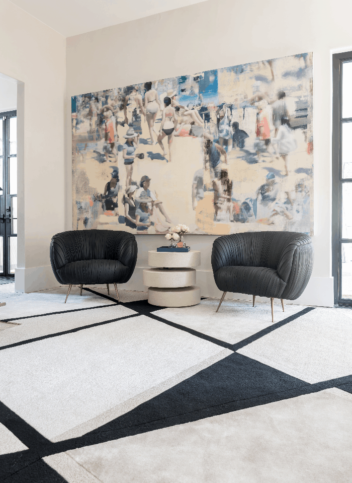 Black and white geometric rug against a colorful art piece: a timeless combination.