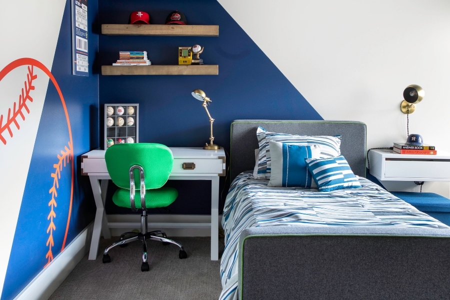 Blue and white sports themed bedroom for boys designed by Laura U