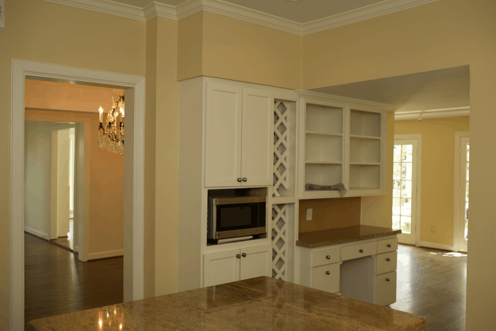 Built in cabinets and desk space in kitchen of Houston home before renovations were complete
