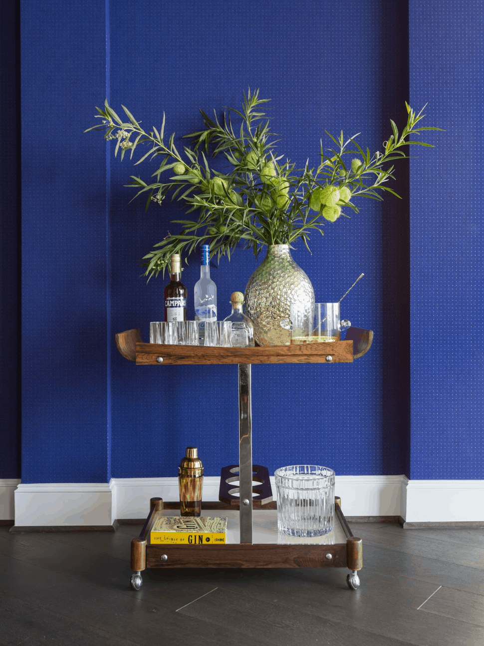 Cobalt blue bar cart with vintage spirits and barware - Laura U Interior Design