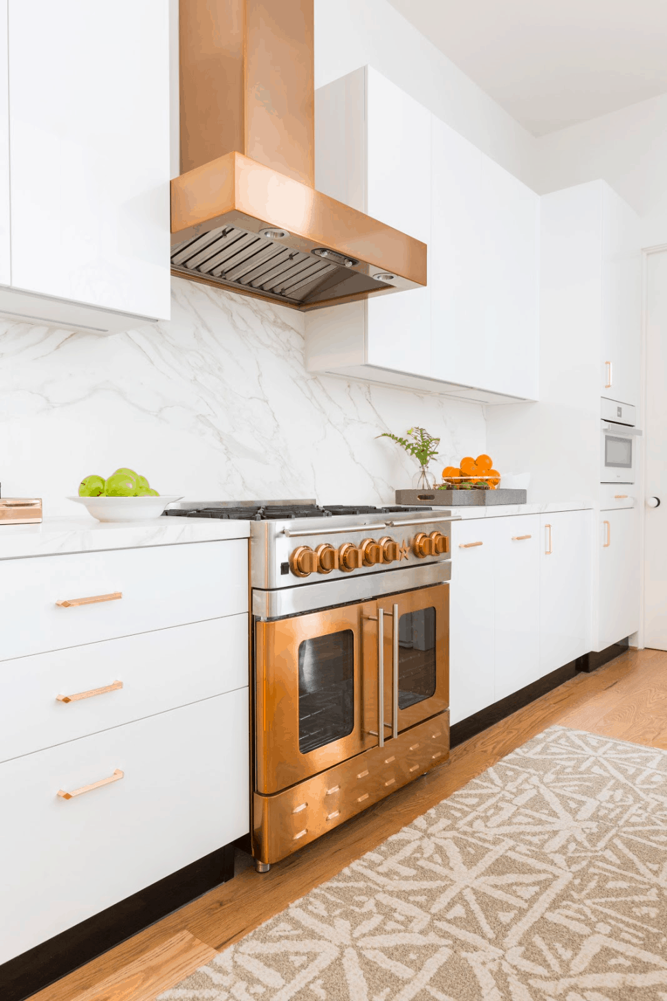 Copper and white kitchen with copper venthood and drawer pulls - Laura U Interior Design