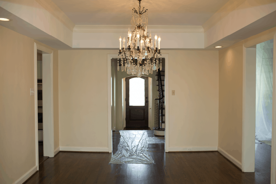 Dining room featuring traditional chandelier and recessed ceiling in Houston home renovation