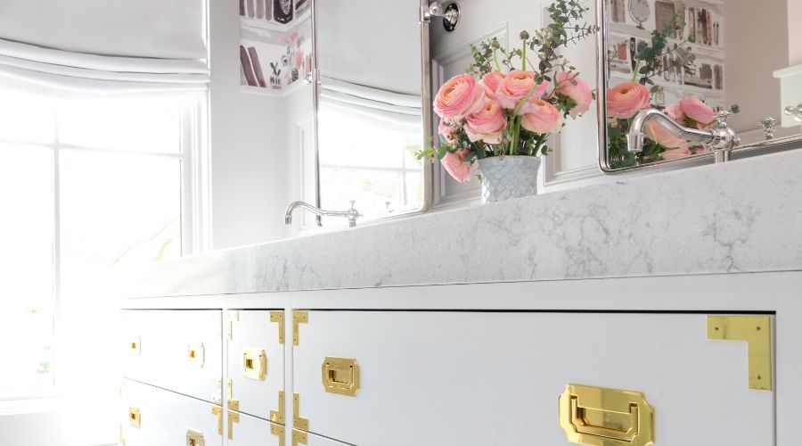 Gold fittings elevate this girls' bathroom in Houston - fresh flowers decorate the counter