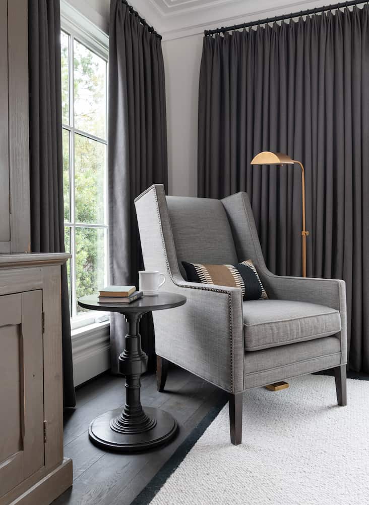 Gray accent chair with brass floor lamp - Houston home renovation by Laura U