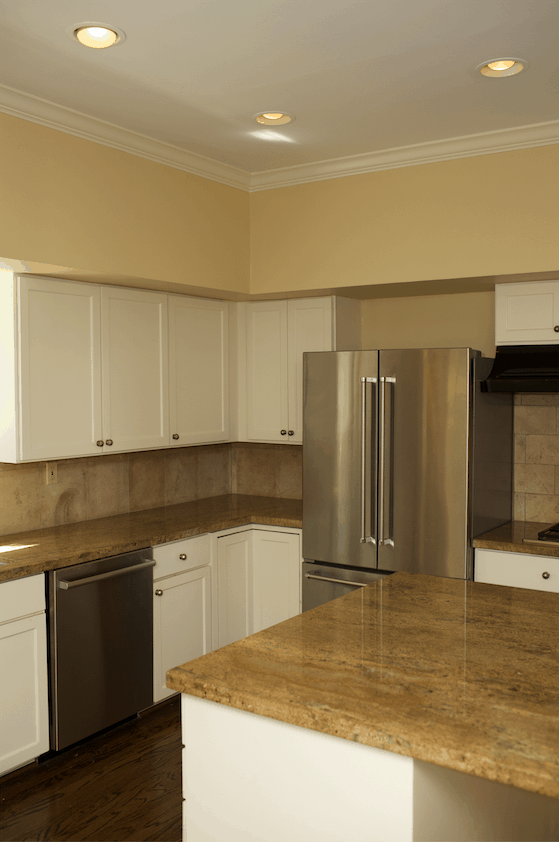 Kitchen space with white cabinets, hardwood floors, and granite counter tops