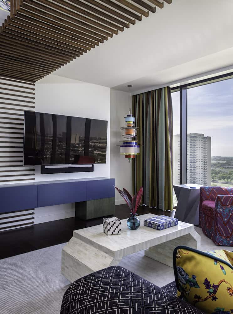 Luxury high rise interior design featuring custom media cabinet designed by Laura U