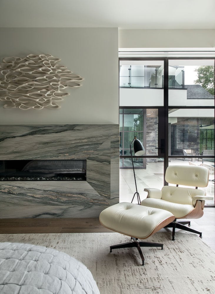 Memorial Interior Design | Master sitting area with white leather Eames chair and modern art