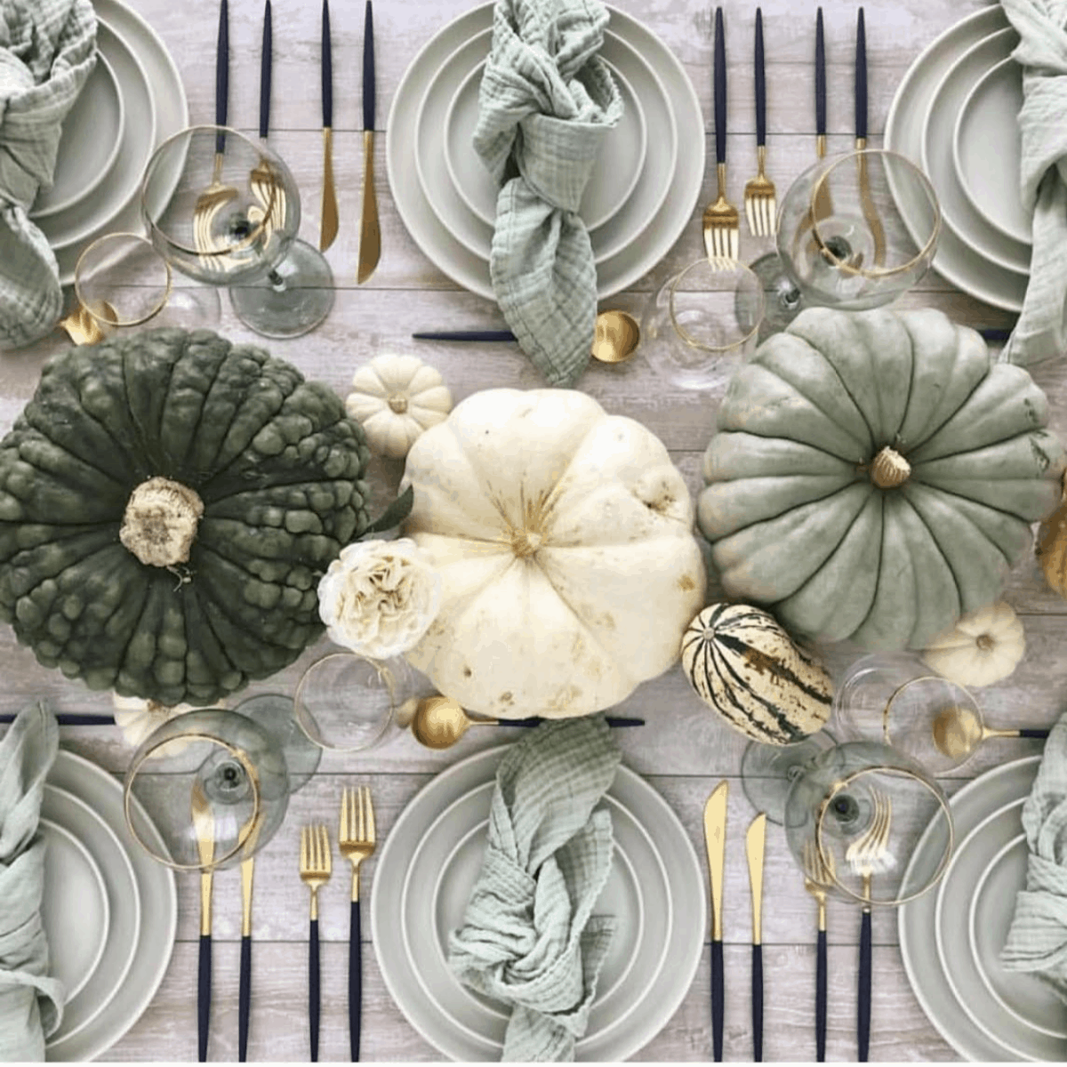Modern Thanksgiving tablescape idea with sage green, cream, and navy color palette