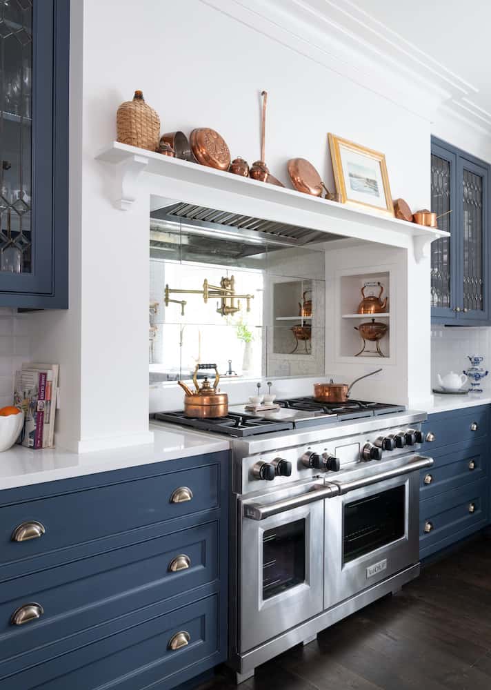 Navy and kitchen kitchen with copper accents designed by Laura U Interior Design