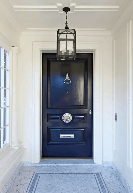 Selecting your front door. Dark navy traditional front door, marble flooring 