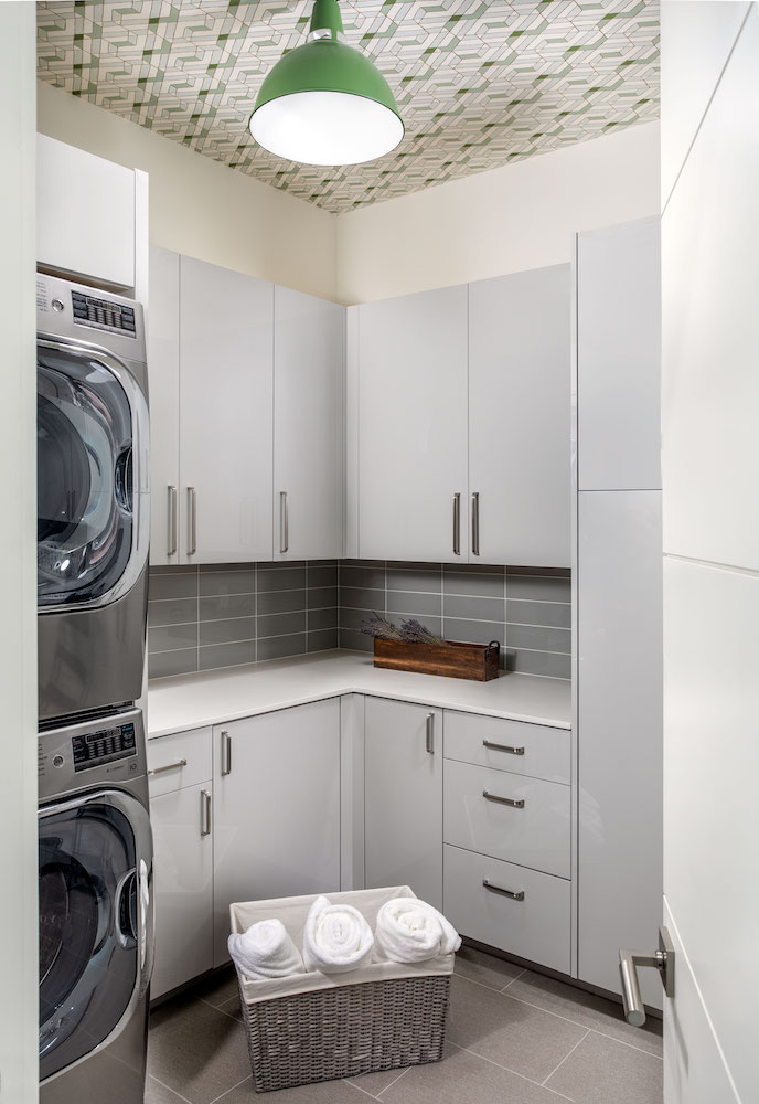 Sleek laundry room with energy-efficient appliances in LEED ceritifed home in Memorial