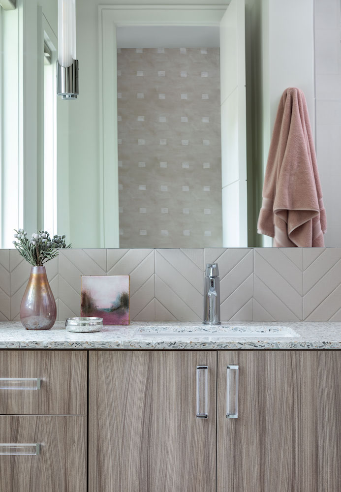 Sophisticated and feminine bathroom with Vetrazzo counters designed by Laura U