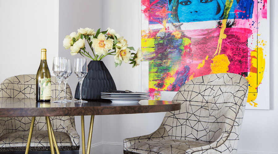 The dining room of 18 Astoria completed with a bold painting and custom furniture.