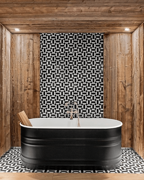 This black soaker tub is reminiscent of vintage washbins, utilitarian and chic