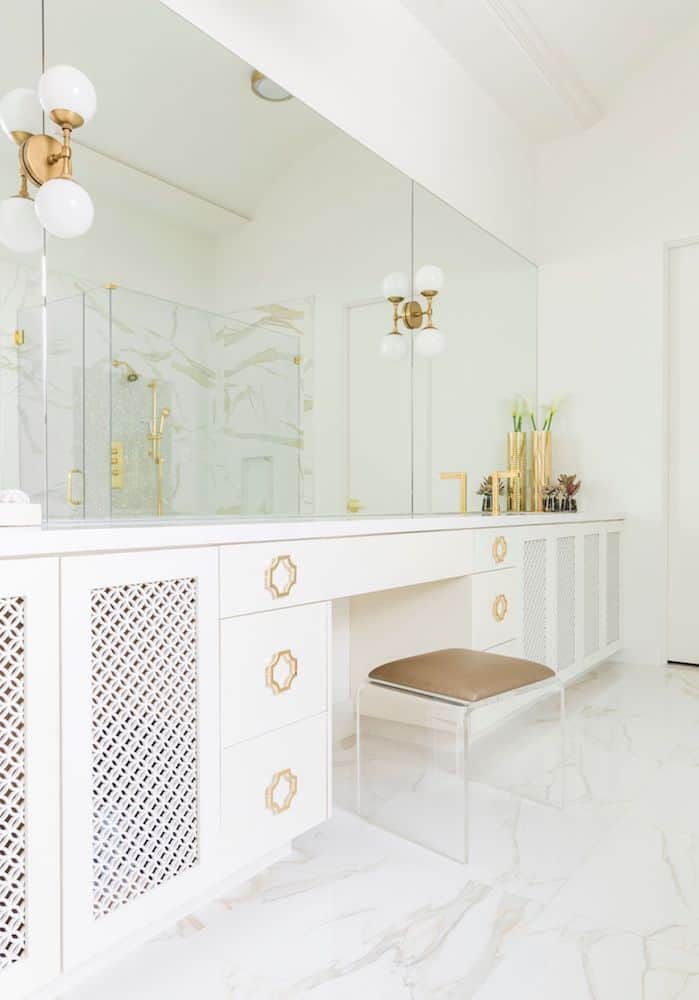 This lucite stool is functional and takes up little visual space in this bathroom.