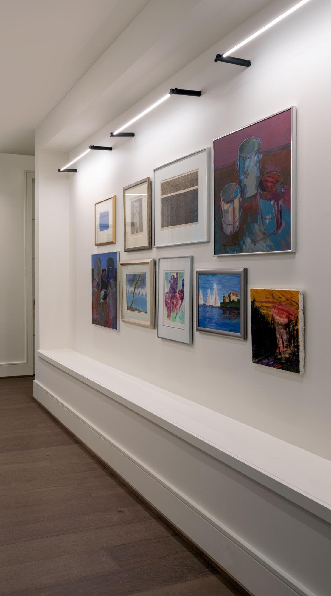 Colorful gallery wall with family artwork in a Memorial, Houston home.