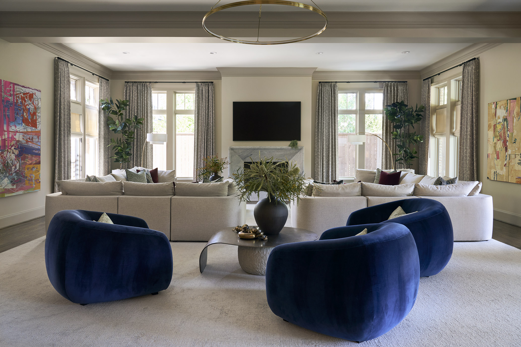 A transitional living room with contemporary art and bold, puffy furnishings