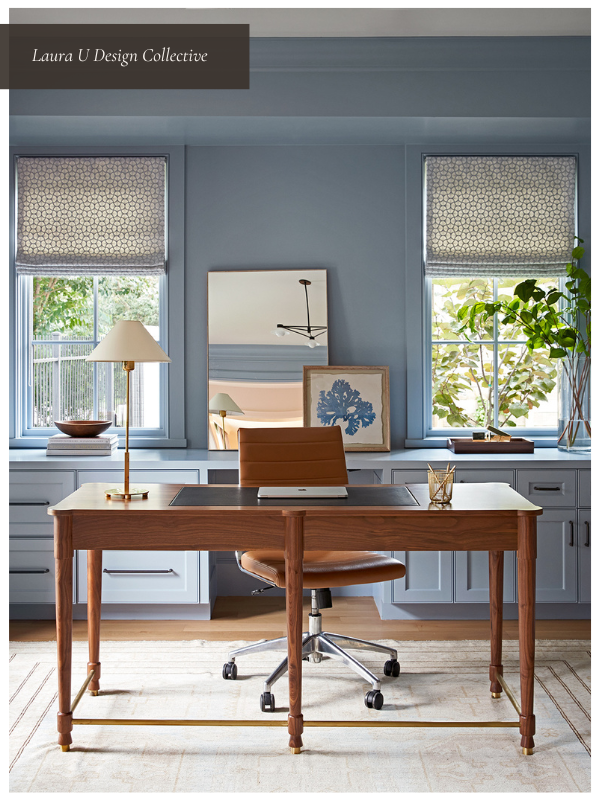 Bright, functional home office layout with dual windows, light blue cabinetry, and wood furniture.