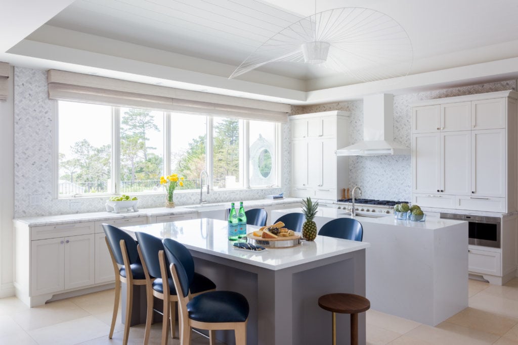 A white kitchen with blue barstools in Pebble Beach, CA