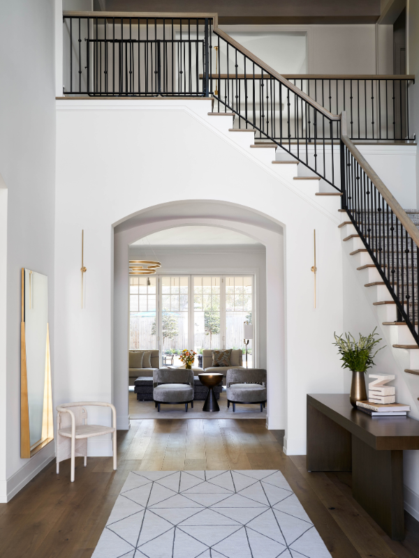 Entry way with a curving staircase of Rice Residence in Houston, Texas