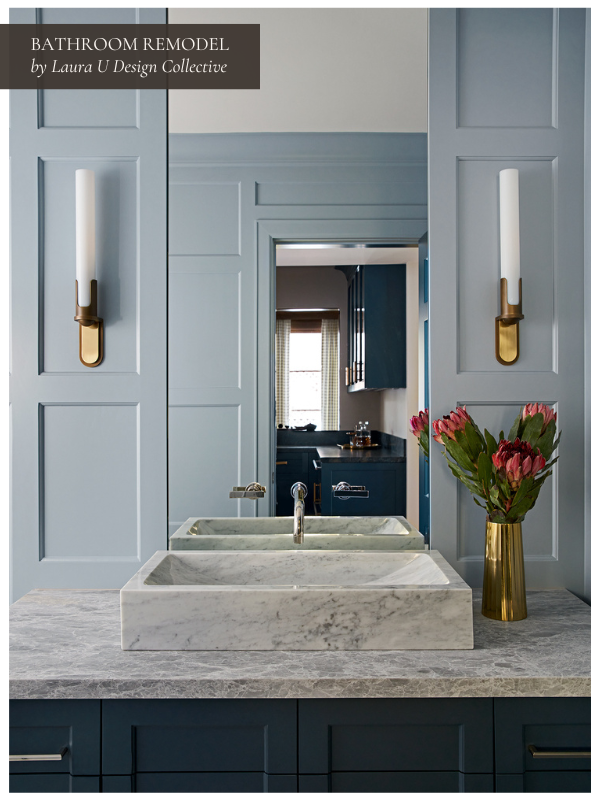 Refined powder bathroom with a marble vessel sink, blue custom cabinetry, and tall sconces. This bathroom design includes new vanity elements and natural light, adding style while balancing bathroom remodel costs with high-end materials and smart square footage use.