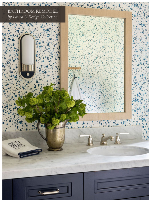 Bright and cheerful bathroom remodel with marble countertop, blue vanity, and speckled accent wall. Features like new fixtures, a small vanity, and fresh decor keep bathroom renovation costs moderate while enhancing the aesthetic of a full bathroom.