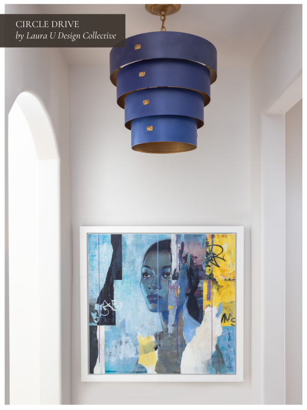 Hallway gallery with layered blue chandelier and bold contemporary portrait art