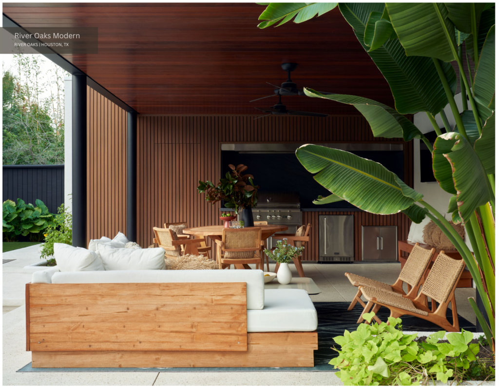 Leafy plants surrounding an outdoor kitchen with natural textures and blonde wood