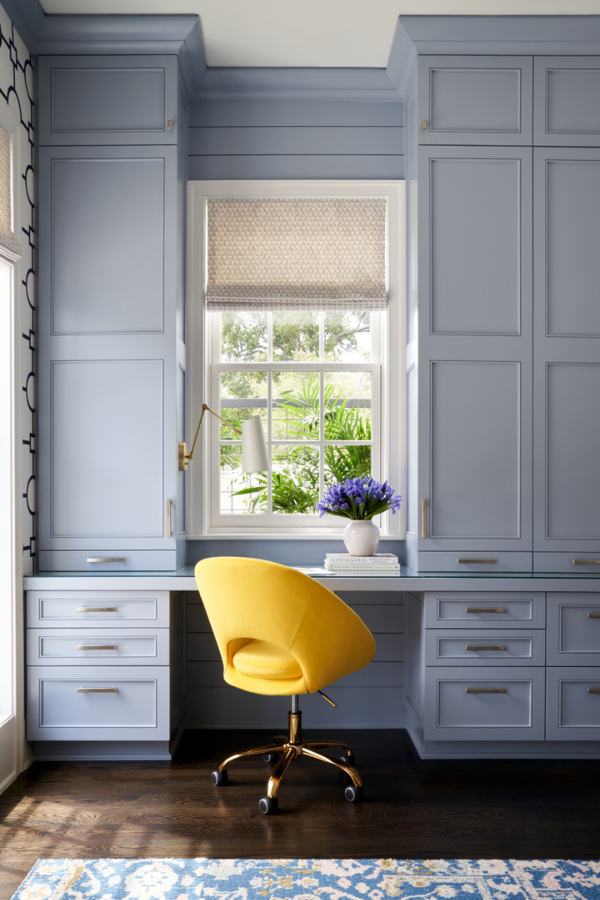 a blue and yellow study space with a window