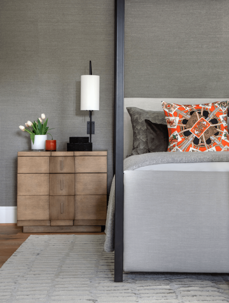 Grey wallpaper, brown wooden side tables, look gorgeous in this Dunstan master bedroom. 