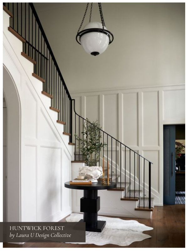 the black and white foyer in our Huntwick Forest project with bold millwork around the staircase