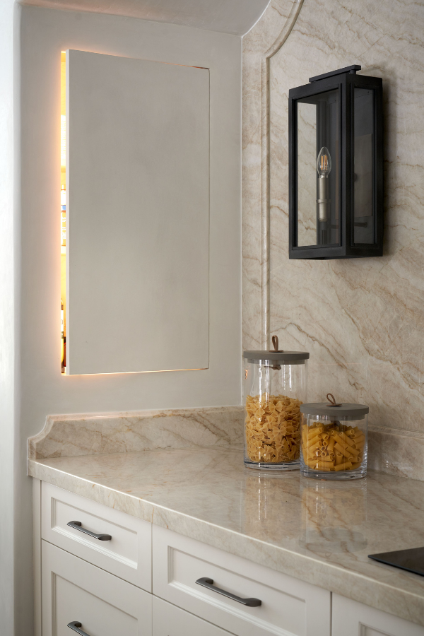 Save precious counter space with kitchen storage solutions like the hidden cabinet pictured above