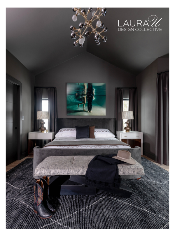 Dark contemporary bedroom with gray upholstered bed, layered sleeping pillows, and one accent pillow.