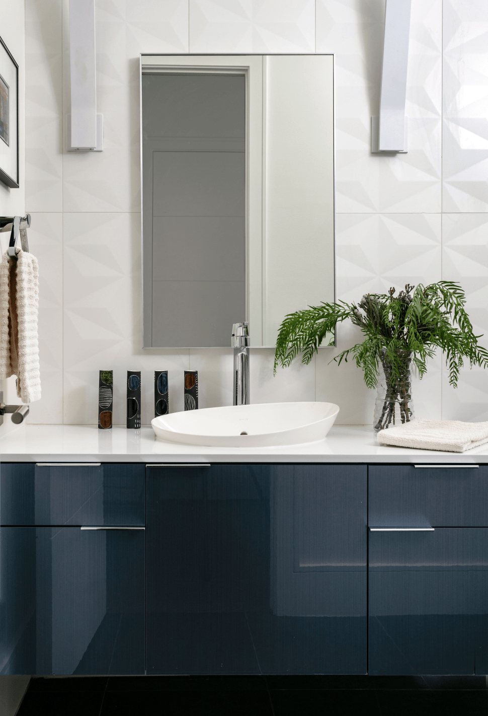 Small powder bath with blue cabinets, white countertop, and white wall tiles by LauraU